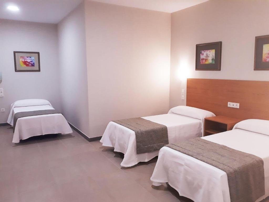 Triple Room at Hostal Montemayor with three single beds